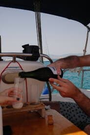 A joyful moment aboard a boat as friends pour champagne, perfect for celebrating special occasions on the water.
