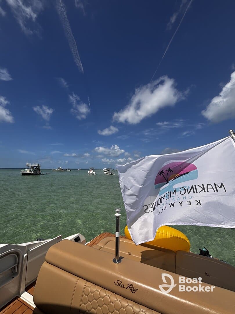 A scenic view from the deck of a Sea Ray boat, showcasing clear waters and a vibrant sky, perfect for enjoying a day on the water in the Florida Keys.