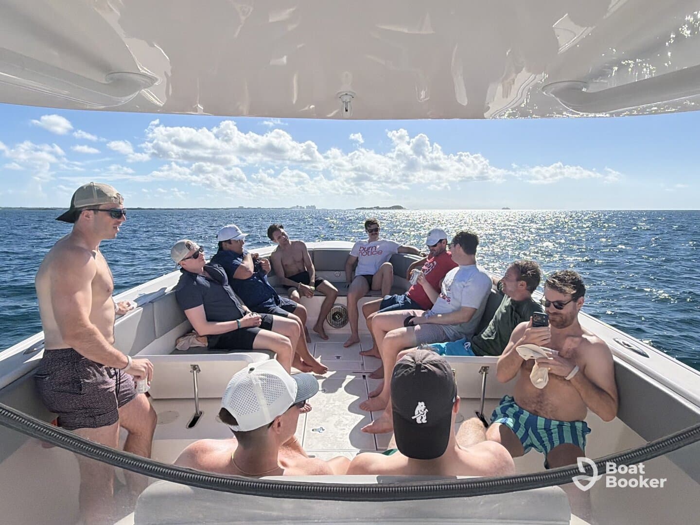 A lively group of friends enjoys a sunny day on the water, relaxing and socializing aboard a boat — perfect for a fun day out with friends.
