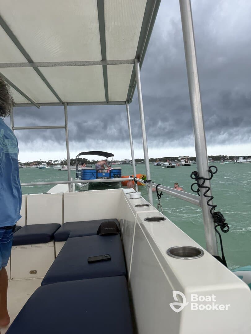 A lively scene aboard a boat with guests enjoying the water, showcasing the fun and excitement of a day on the water.