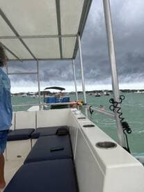 A lively scene aboard a boat with guests enjoying the water, showcasing the fun and excitement of a day on the water.