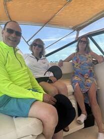 A group of friends relaxes inside a boat, enjoying their time together on the water. Perfect for capturing memorable moments during a boating adventure.