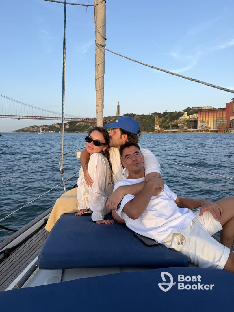 A joyful group enjoys a sunset cruise on a yacht, capturing a moment of togetherness against a stunning backdrop of the city skyline.