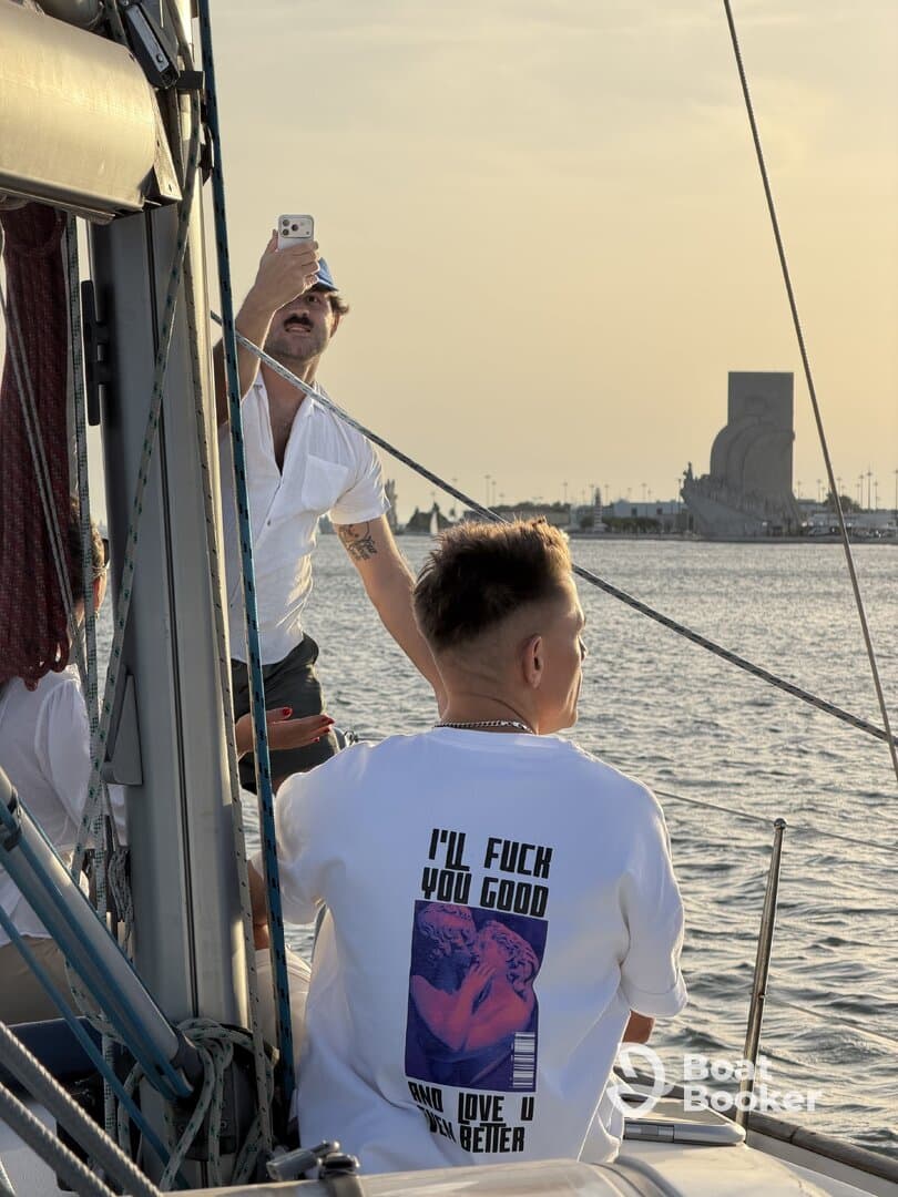 A lively group enjoys a sunset moment on a boat, capturing memories and celebrating together — perfect for social gatherings on the water.