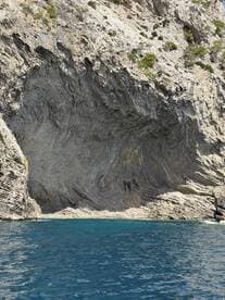 A stunning view of a unique rock formation along the coastline, showcasing the natural beauty of the area — perfect for nature lovers and scenic boat tours.