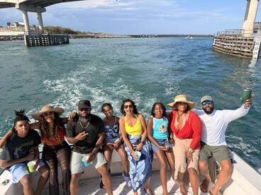 A lively group enjoys a fun day on the water, celebrating together aboard a boat — perfect for family outings or group adventures.