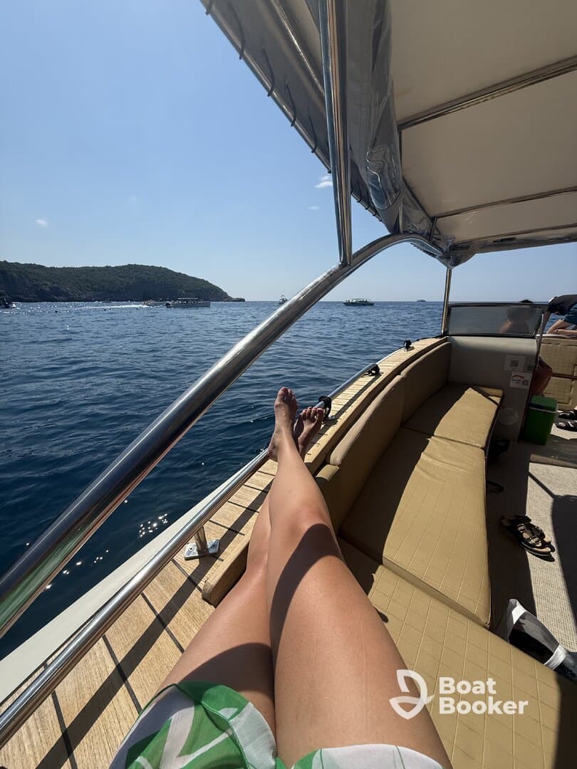 A relaxing moment on the boat's lounge area, showcasing a sunny day on the water — perfect for unwinding and enjoying the scenic views.