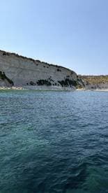 A stunning view of a rocky coastline with clear waters, perfect for exploring by boat or enjoying a scenic cruise.