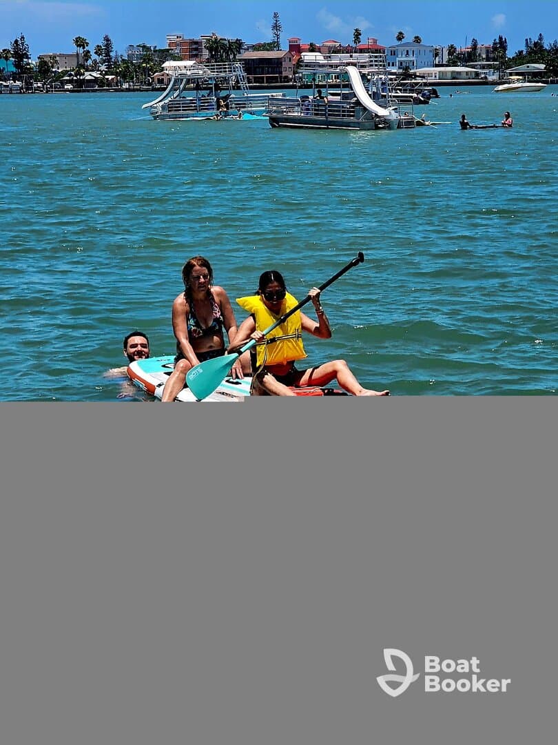 A group enjoys paddleboarding in vibrant waters, showcasing a fun day of water activities and camaraderie under the sun.
