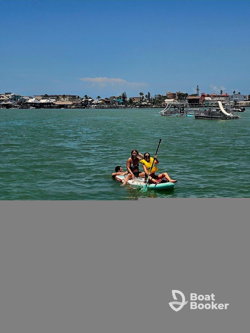A group enjoys paddleboarding on a sunny day, showcasing fun water activities and camaraderie in a vibrant setting.