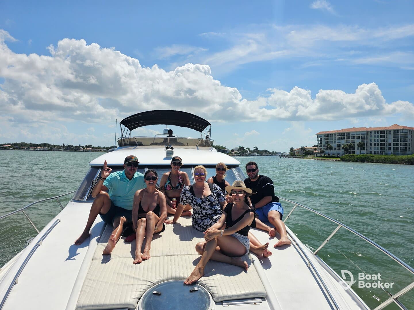 A lively group enjoys a sunny day on a boat, capturing the essence of fun and celebration on the water.