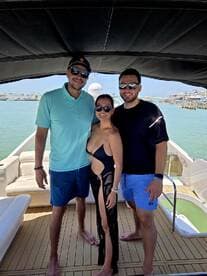 A group of friends poses together on a boat, enjoying a sunny day on the water — perfect for memorable outings and celebrations.