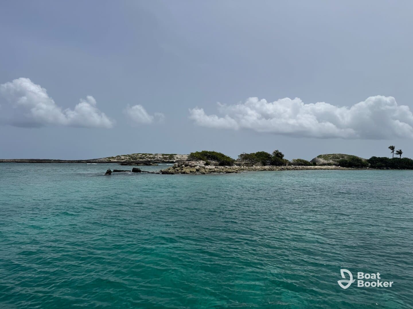 A serene view of a secluded island surrounded by clear turquoise waters, perfect for exploring the natural beauty of coastal destinations.