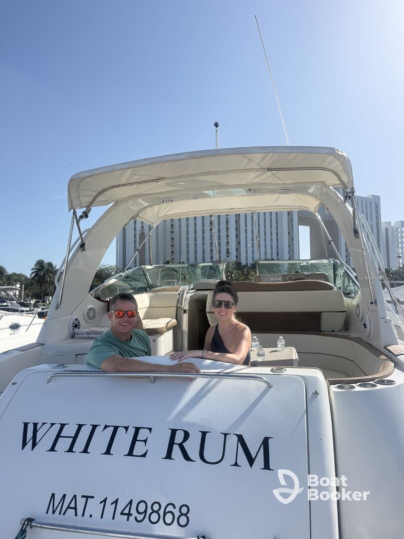 A couple enjoys a sunny day aboard the 'White Rum' yacht, perfect for romantic outings or celebrations on the water.
