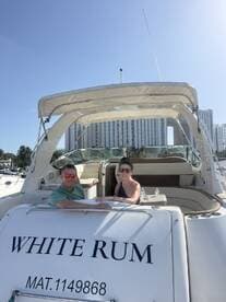 A couple enjoys a sunny day aboard the 'White Rum' yacht, perfect for romantic outings or celebrations on the water.