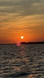 A stunning sunset over calm waters, capturing the serene beauty of the evening sky — perfect for romantic boat cruises or peaceful reflections.