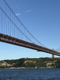 A scenic view of a bridge spanning over water, showcasing the natural landscape and architectural beauty.