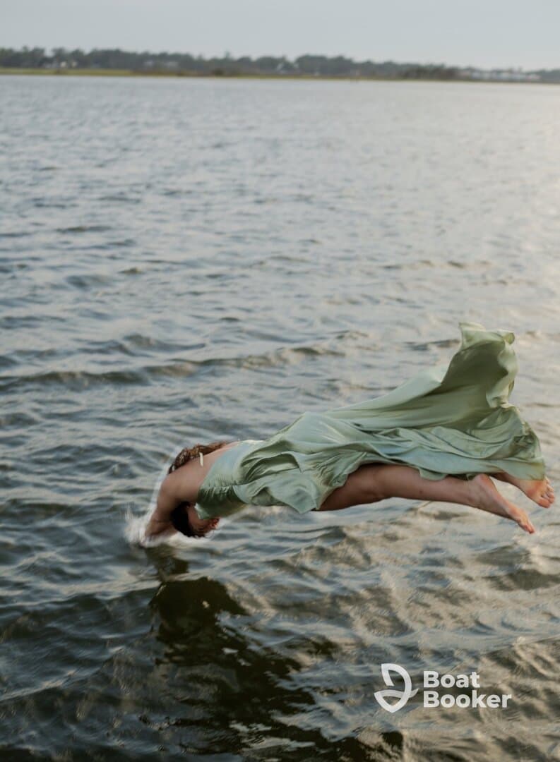 A person leaps gracefully into the water, capturing the thrill of summer fun and adventure on the water.