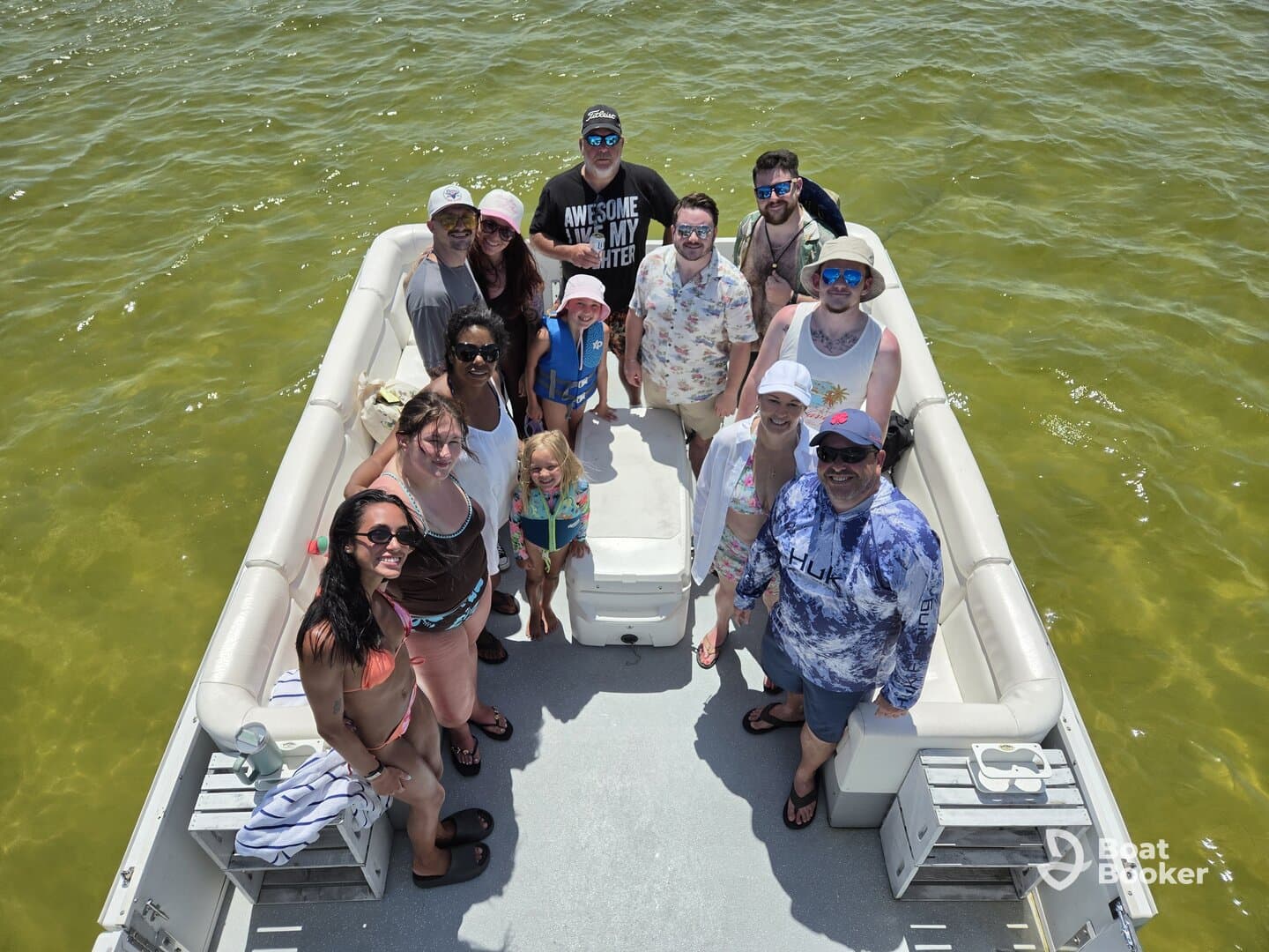 A lively group of friends and family enjoy a sunny day on a pontoon boat, creating unforgettable memories on the water.