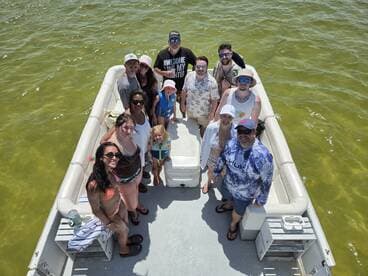 A lively group of friends and family enjoy a sunny day on a pontoon boat, creating unforgettable memories on the water.