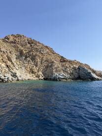 A stunning view of rugged cliffs meeting the clear blue waters, showcasing the natural beauty of the coastline — perfect for scenic boat tours.