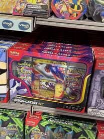 A display of various Pokémon card products, showcasing different packaging and collectibles on store shelves.