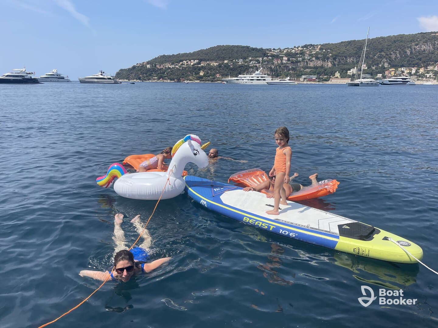 A fun day on the water with a group enjoying inflatable floats and paddleboarding, perfect for family adventures and summer outings.