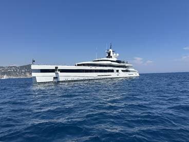 A stunning yacht glides through the clear blue waters, showcasing its sleek design and elegance — perfect for luxury charters and coastal adventures.