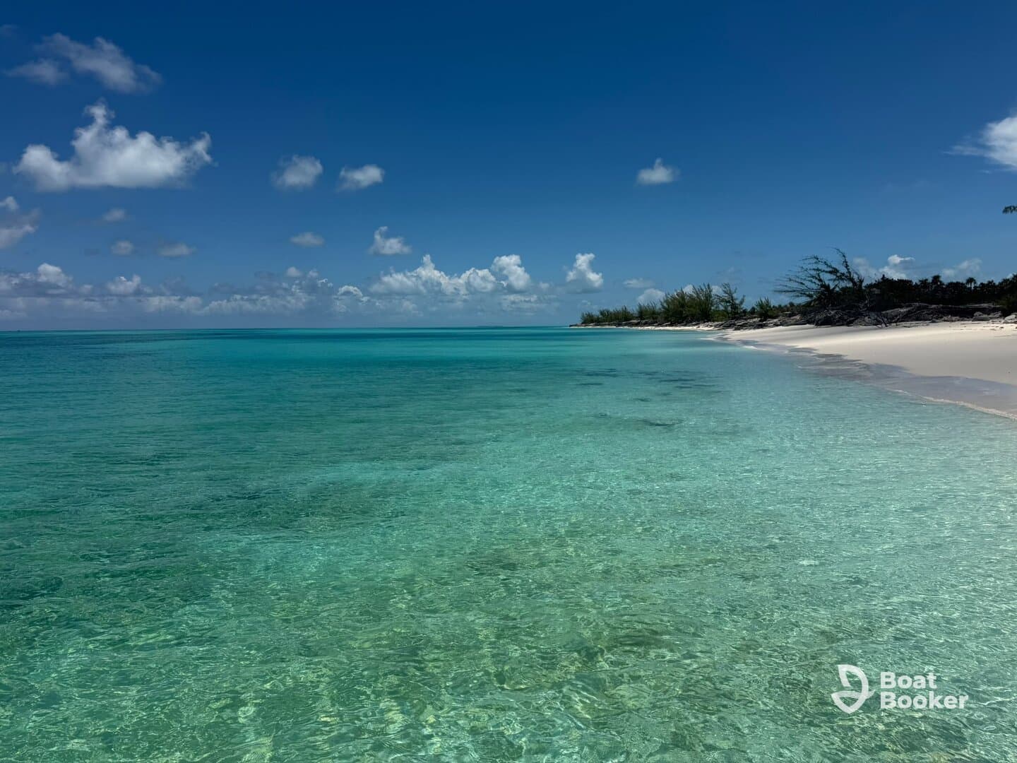 A stunning view of a serene beach with crystal-clear waters and a picturesque coastline, perfect for relaxation and exploration in tropical paradise.