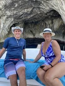 A couple enjoys a relaxing moment on a boat inside a stunning cave, perfect for memorable adventures and scenic explorations.