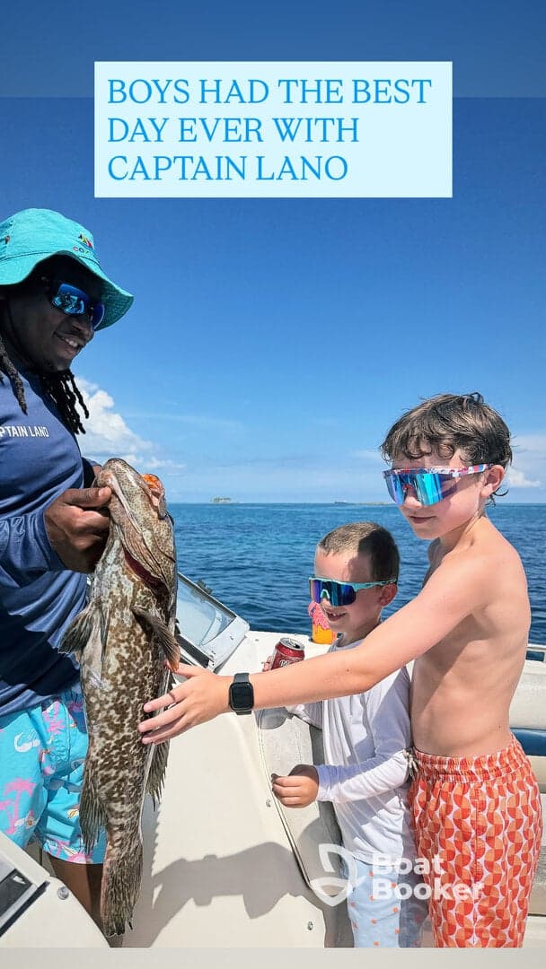 Two boys celebrate their catch with Captain Lano while fishing on a boat — a memorable day on the water filled with excitement and adventure.