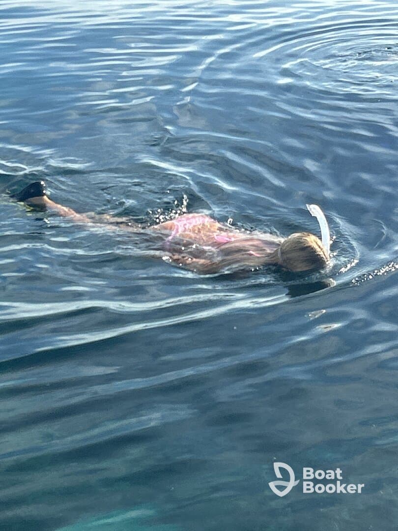 A child enjoys snorkeling in clear waters, showcasing the beauty of underwater exploration — a perfect activity for family adventures on the water.