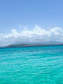 A vibrant scene showcasing turquoise waters and a picturesque coastline, perfect for water activities and relaxation under the sun.