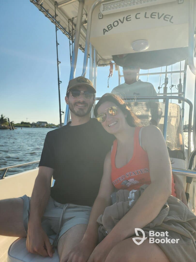 A happy couple enjoys a sunny day on the boat, capturing the essence of a perfect day on the water.