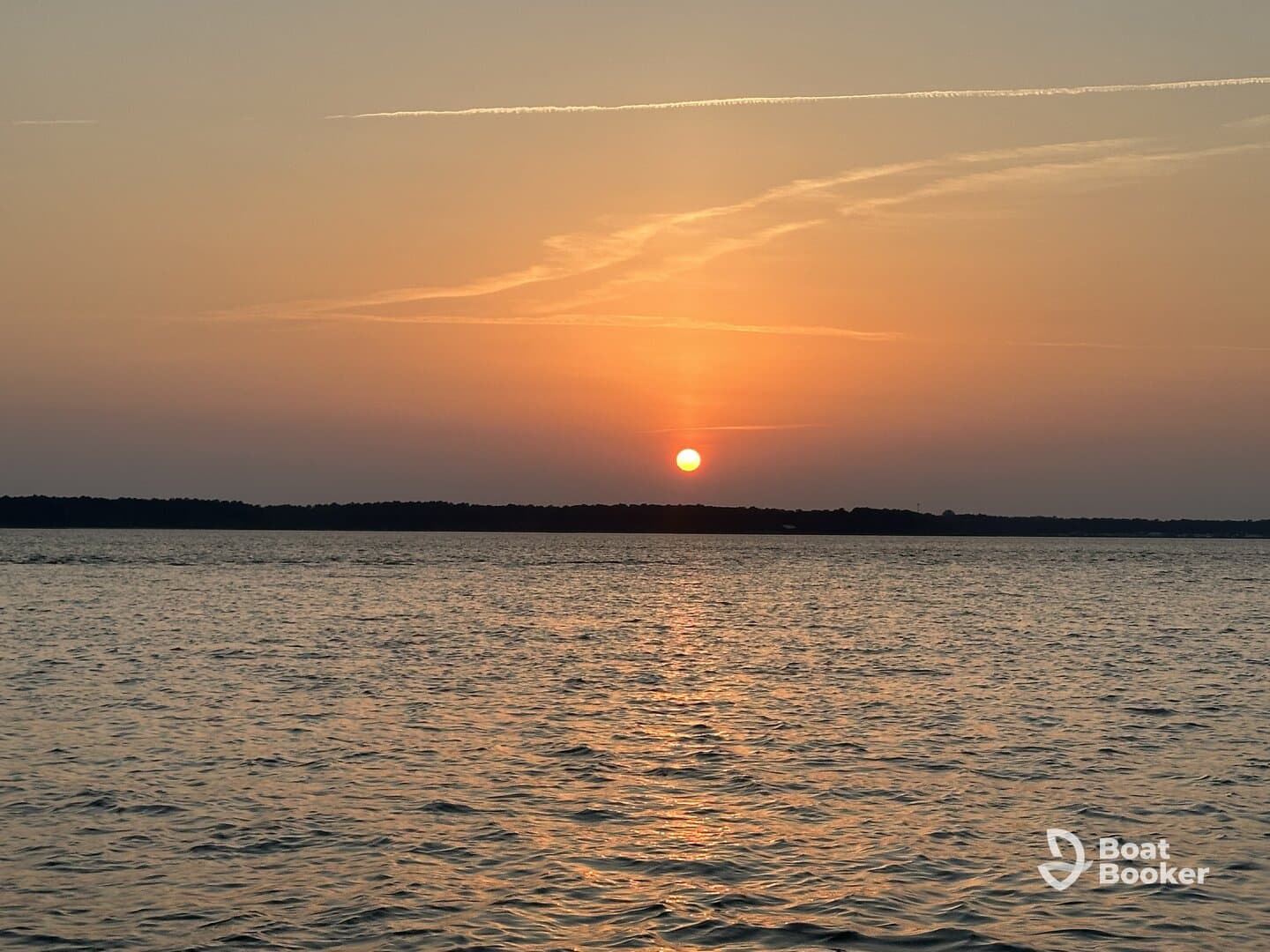 A serene sunset over calm waters, providing a picturesque backdrop for evening boat outings.
