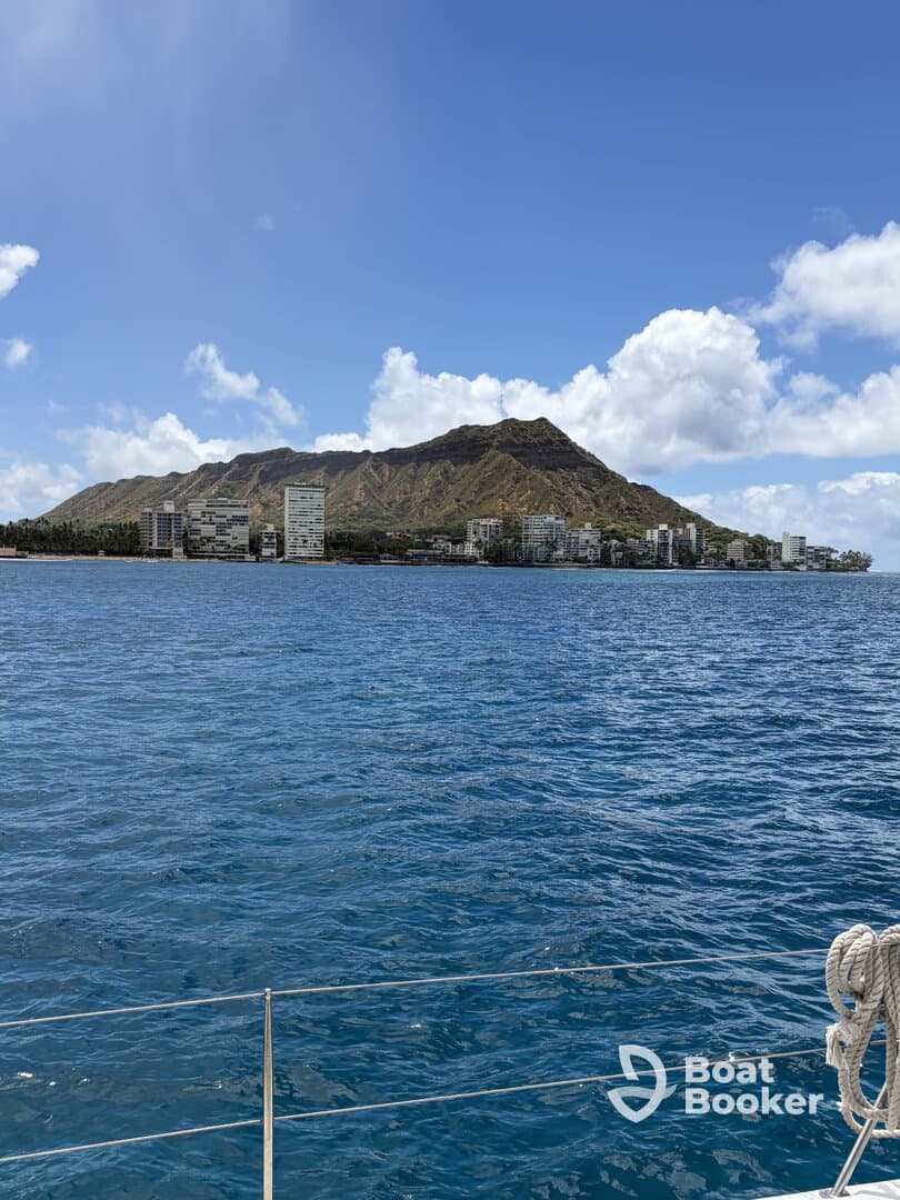 A stunning view of Diamond Head and the coastline of Honolulu from the water, showcasing the beauty of Hawaii's landscape.