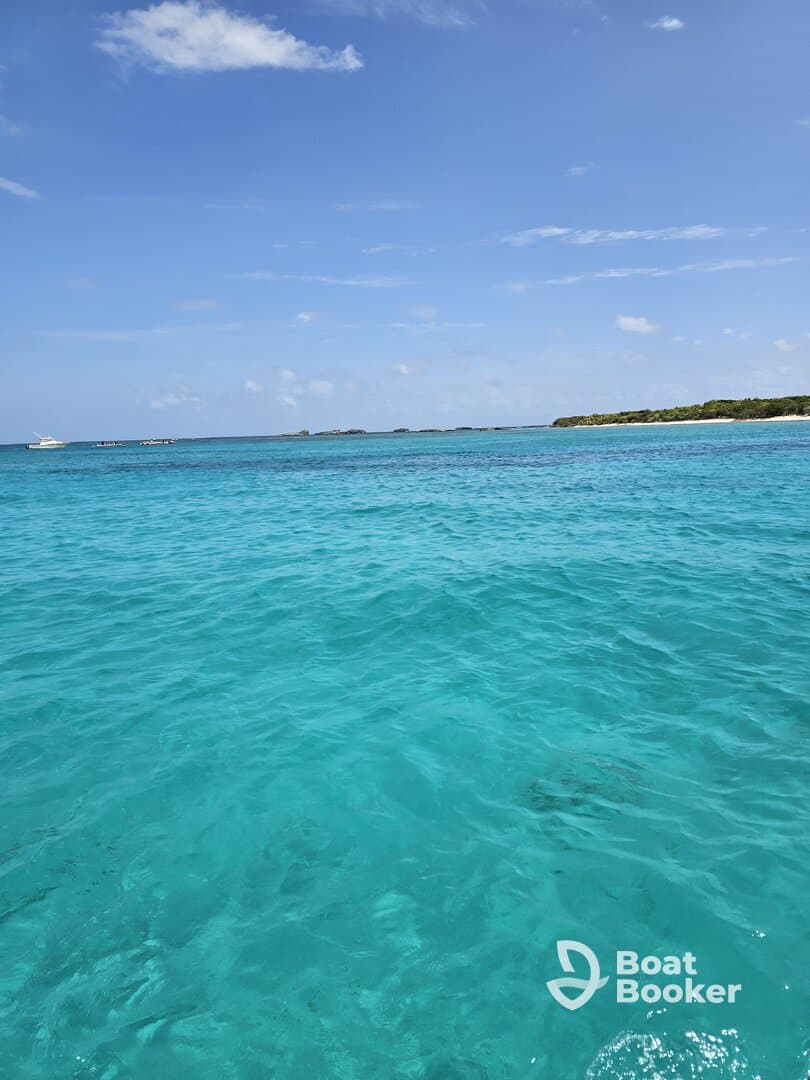 A stunning view of crystal-clear turquoise waters and a picturesque coastline, perfect for showcasing the beauty of a tropical getaway.