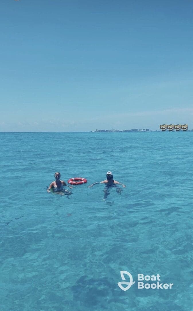 A couple enjoys a refreshing swim in crystal-clear waters, showcasing the perfect tropical getaway experience.