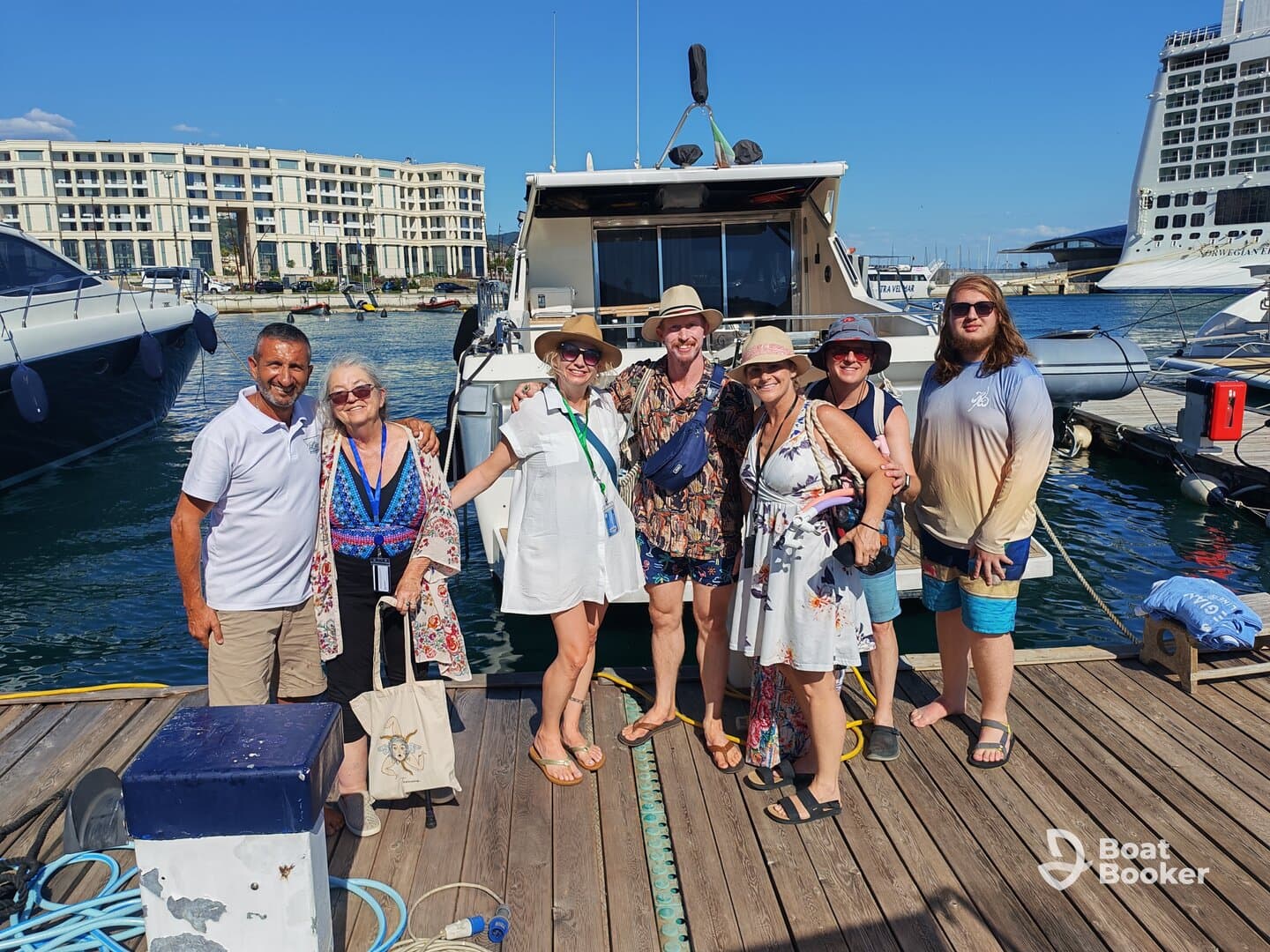 A cheerful group poses together at the dock, ready for a day of adventure on the water. Perfect for showcasing memorable moments with friends and family.