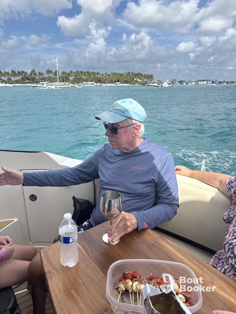 A relaxing moment on a boat with guests enjoying drinks and snacks, perfect for social gatherings on the water.
