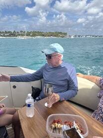 A relaxing moment on a boat with guests enjoying drinks and snacks, perfect for social gatherings on the water.