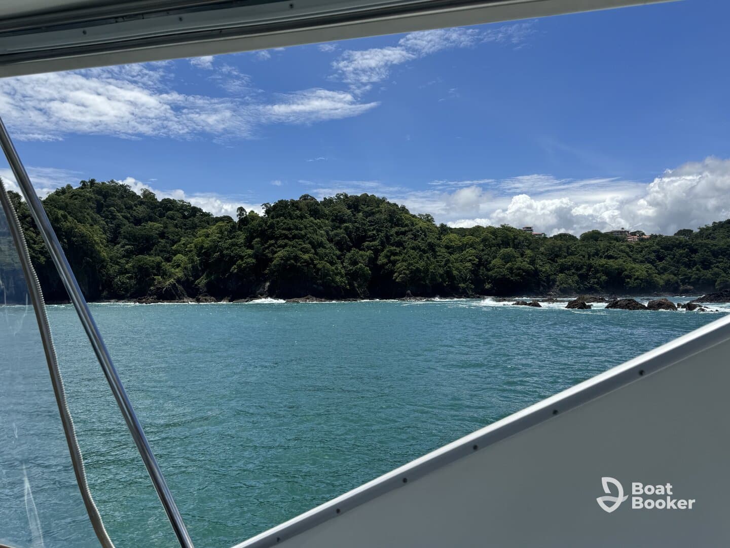 A stunning view from a boat showcasing the lush coastline and turquoise waters, perfect for a scenic cruise or island exploration.