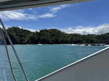 A stunning view from a boat showcasing the lush coastline and turquoise waters, perfect for a scenic cruise or island exploration.