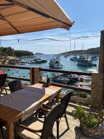 A picturesque view from a restaurant overlooking a harbor filled with various boats, perfect for enjoying a meal while soaking in the coastal scenery.