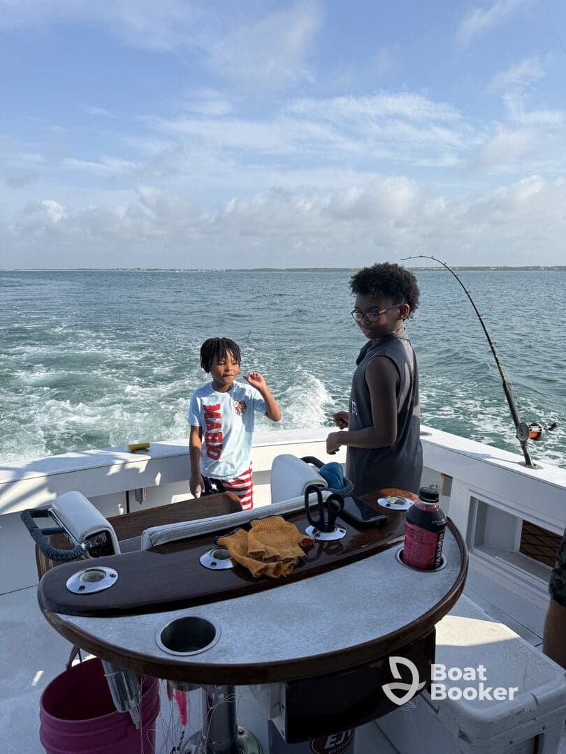 Two children enjoy a fun day of fishing aboard a boat, creating lasting family memories on the open water.