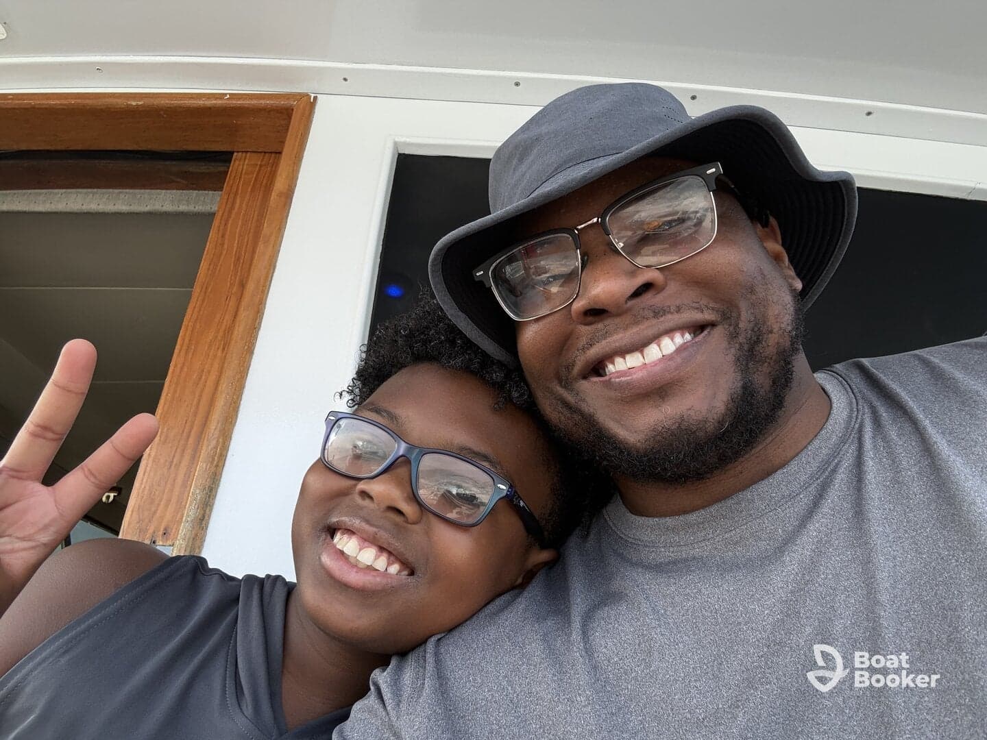 A joyful moment captured between a father and child aboard a boat, showcasing family fun and bonding on the water.