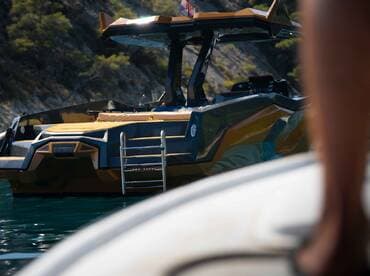 A sleek speedboat is docked in calm waters, showcasing its modern design and inviting atmosphere for a day on the water.