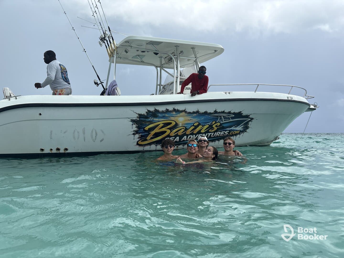A group of friends enjoys a fun day swimming near a fishing boat, creating unforgettable memories on the water with Bain's Sea Adventures.