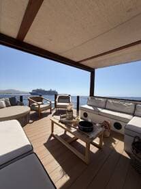 A beautifully designed lounge area on a boat, featuring comfortable seating and a scenic view of the water, perfect for relaxing and enjoying the marine atmosphere.