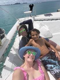 A joyful moment captured on a catamaran, featuring a family enjoying their time together on the water — perfect for creating lasting memories during a fun-filled day at sea.
